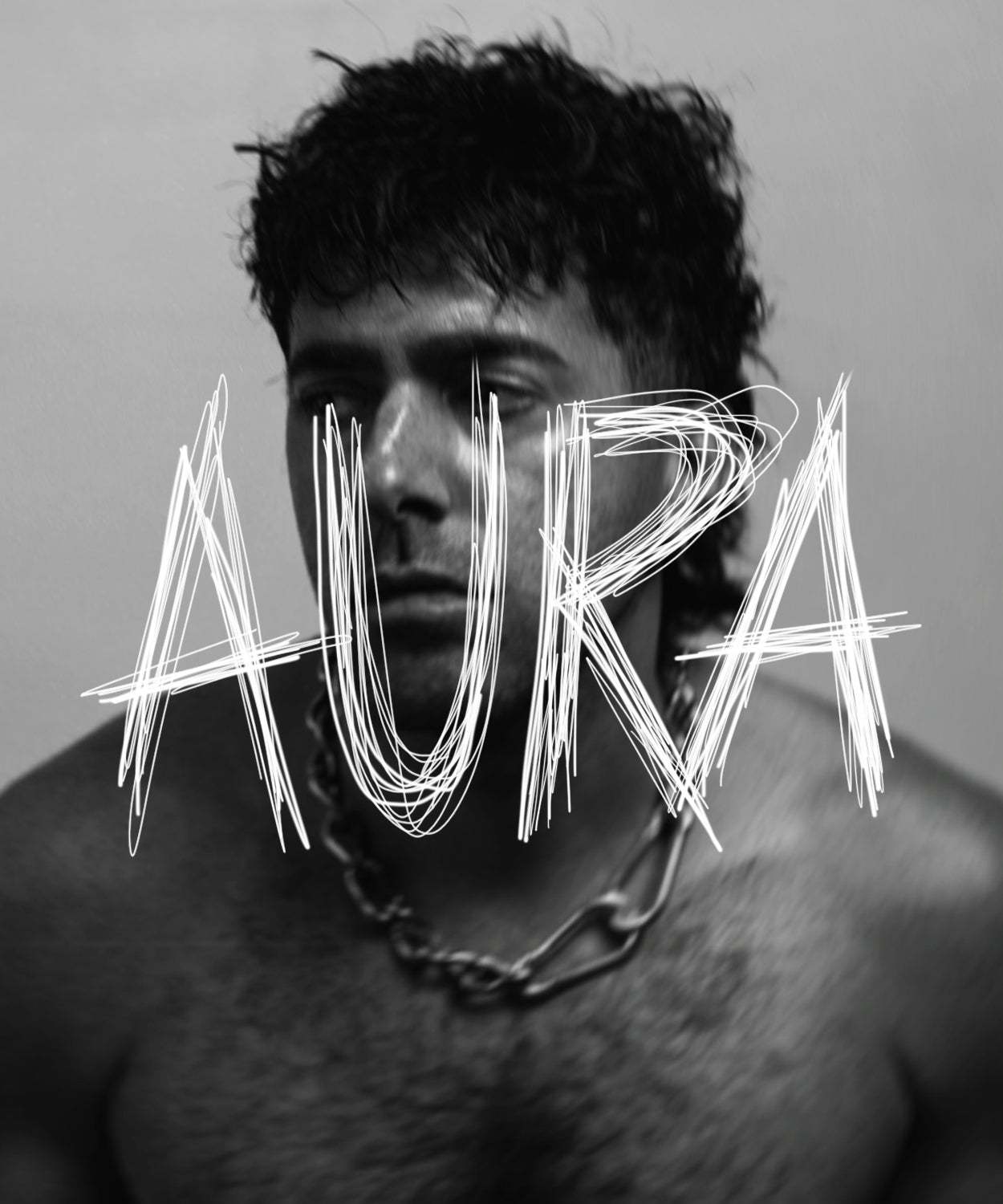 Black and white portrait of Angelo, the brand founder, with the word 'Aura' overlayed in a scratch style handwriting. 
