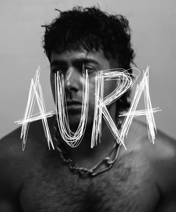 Black and white portrait of Angelo, the brand founder, with the word 'Aura' overlayed in a scratch style handwriting. | AURA BY ANGELO