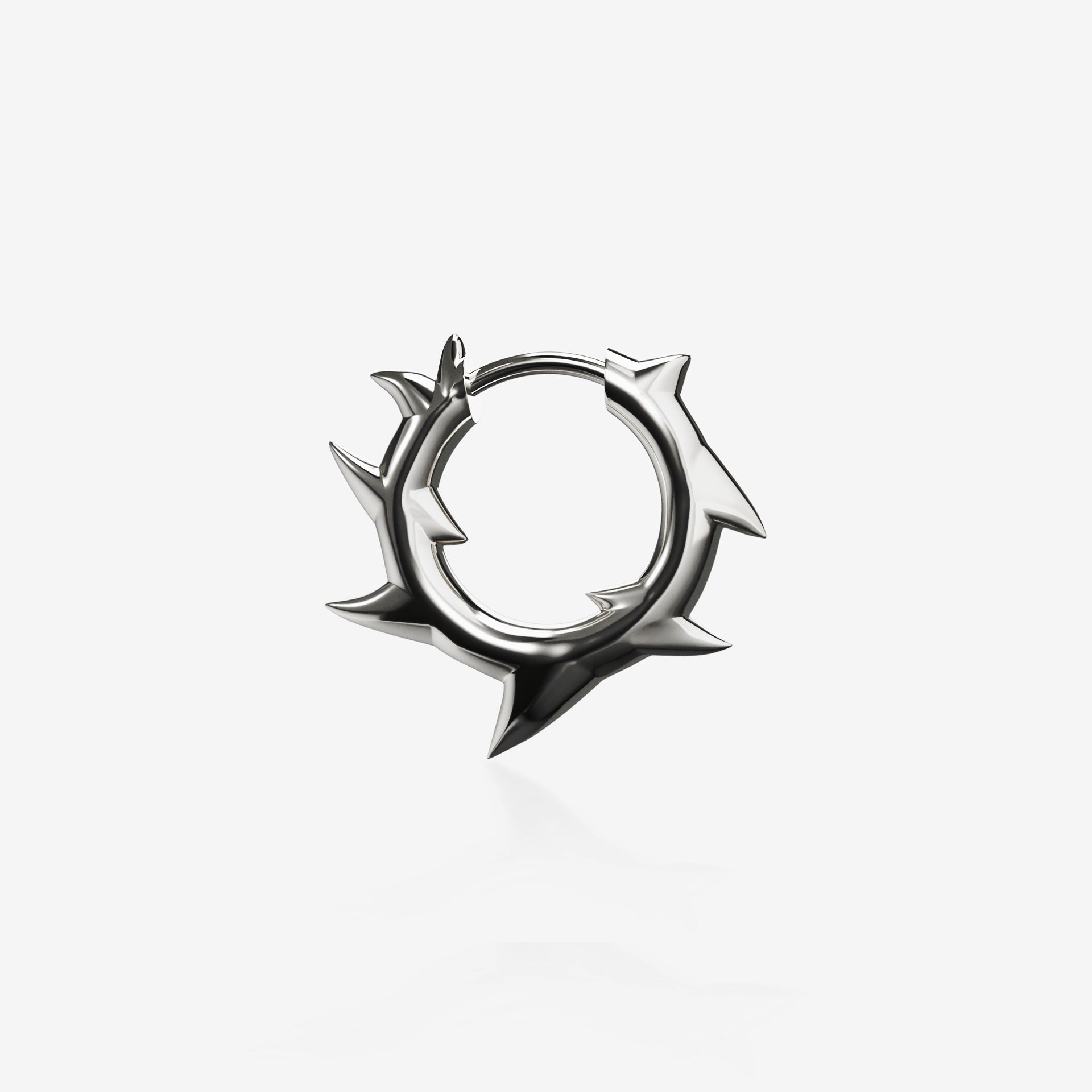 A silver spiked hoop earring against a white backdrop. This is a product lay-flat showcasing the design of the earring. 