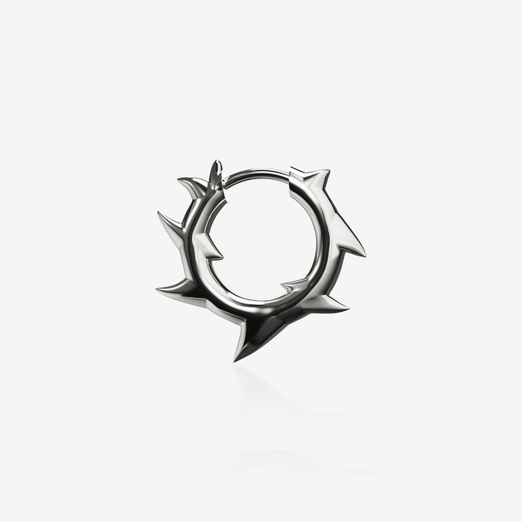 A silver spiked hoop earring against a white backdrop. This is a product lay-flat showcasing the design of the earring. | AURA BY ANGELO