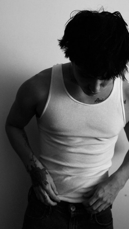 Model Aaron Fuller wears AURA 01 FRAGRANCE from AURA by Angelo 